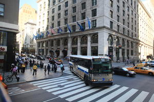 afrocarribean, building, bus, car, couple, crossing, day, elevated, flag, Manhattan, New York, people, standing, street, summer, sunny, taxi, The United States, walking