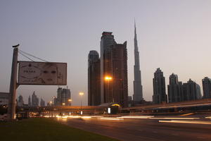 artificial lighting, cityscape, Dubai, Dubayy, dusk, eye level view, flyover, lamppost, outdoor lighting, road, sign, skyscraper, The United Arab Emirates