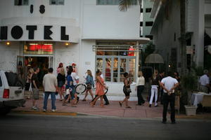 afrocarribean, building, cafe, crowd, dusk, eye level view, Florida, hotel, Miami, people, retail, standing, street, summer, The United States, walking, winter