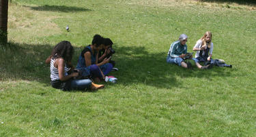 casual, day, England, eye level view, grass, group, London, park, people, shady, sitting, summer, sunny, The United Kingdom