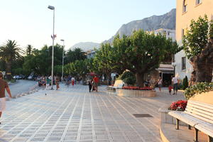 bench, couple, Croatia, day, dusk, eye level view, family, group, lamppost, Makarska, people, road, Splitsko-Dalmatinska, square, tree, vegetation