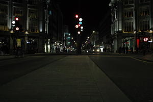 artificial lighting, city lights, England, eye level view, London, night, outdoor lighting, pavement, street, The United Kingdom